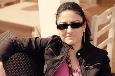 Portrait of woman wearing sunglasses at home