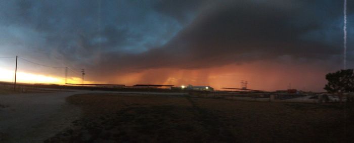 Cars on road against sky at sunset