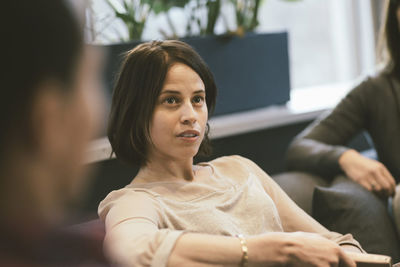 Serious businesswoman listening in meeting at office