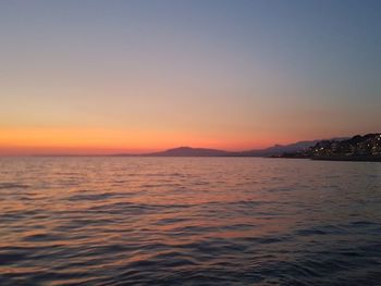 Scenic view of sea against clear sky during sunset