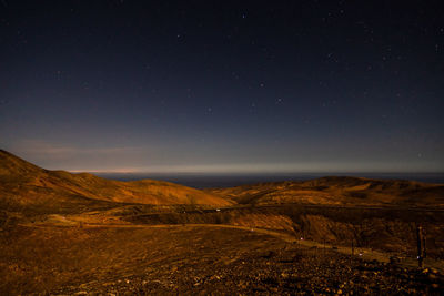 Aerial view of landscape against sky at night