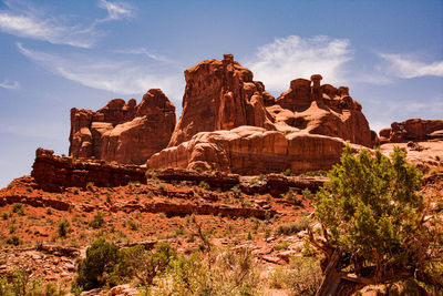 Rock formations on mountain against cloudy sky