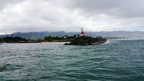 Boat sailing on sea against sky