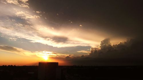 Silhouette cityscape against sky during sunset