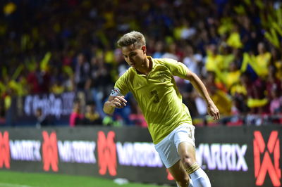 Low angle view of man running on soccer field