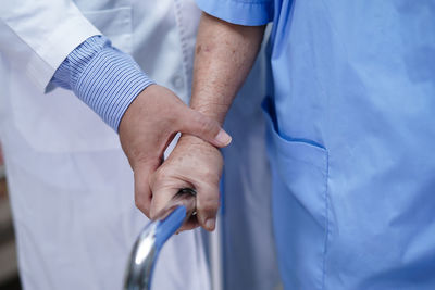 Midsection of man holding hands