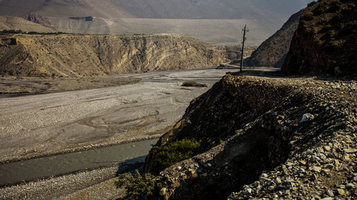 Road by rocks against mountains