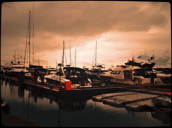 Boats in harbor at sunset