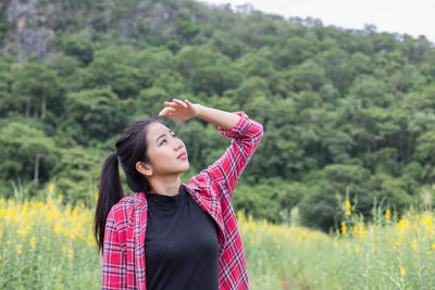 Young woman standing on field