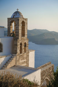 View of church by sea against sky