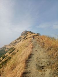 Mid distance view of man on mountain against sky