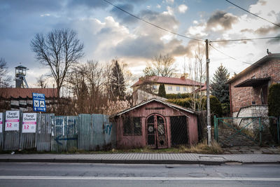 Houses by street against sky in city