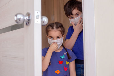 Side view of mother and daughter in bathroom