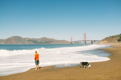 Full length of woman standing on shore