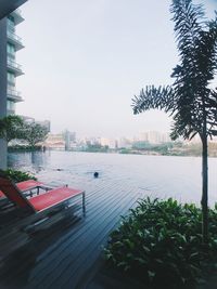 Swimming pool by buildings against sky