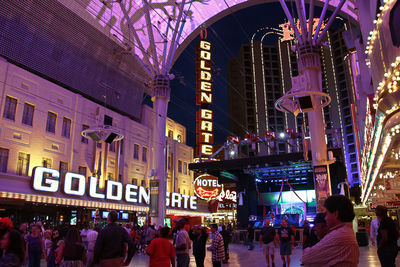 People on illuminated street at night