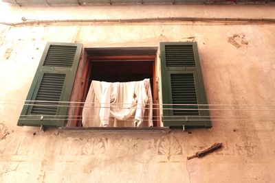 Low angle view of clothes drying against window