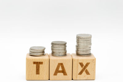 Close-up of coins on table against white background