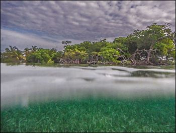 Scenic view of landscape against cloudy sky