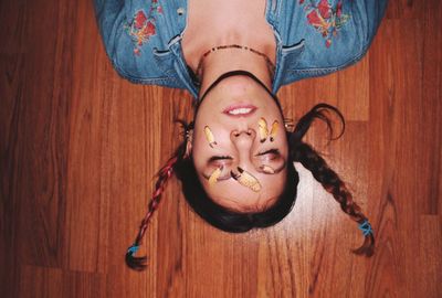 Low section of woman with tattoo on hardwood floor