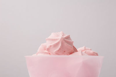 Close-up of pink cake against white background
