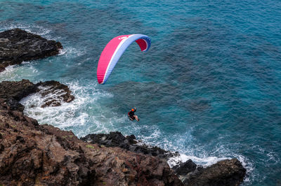 High angle view of man parachuting above sea