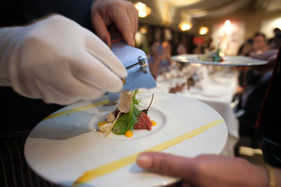 Close-up of man preparing food in restaurant