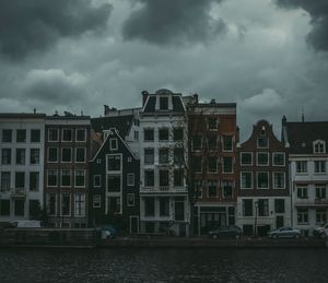 View of houses against cloudy sky