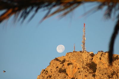 Low angle view of telephone pole against clear sky