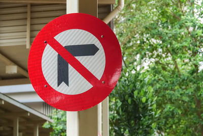 Low angle view of no right turn sign against trees