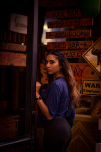 Side view of young woman standing at home