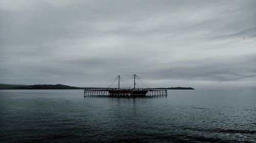 Sailboat in sea against sky