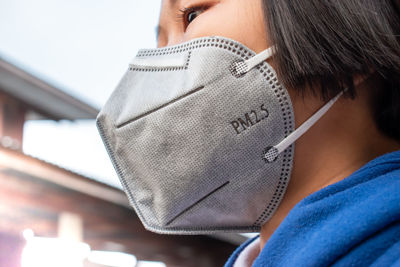 Close-up of girl wearing pollution mask