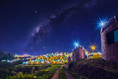 Illuminated building against sky at night