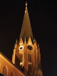 Low angle view of bell tower against sky at night