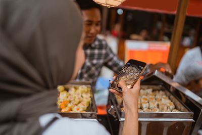 Midsection of man holding food