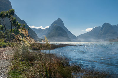 Mitre peak towering above the morning fog in milford sound