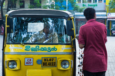 Rear view of man traveling in bus