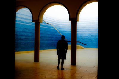 Rear view of woman standing in water