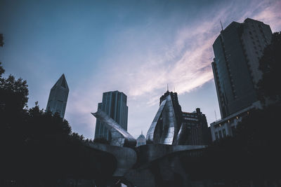 Low angle view of buildings against sky during sunset