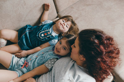 High angle view of mother and daughter lying down