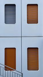 Low angle view of building facade with orange windows