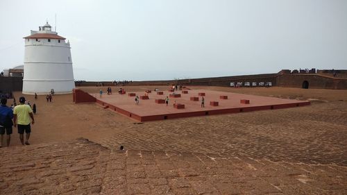 High angle view of people standing on land against sky