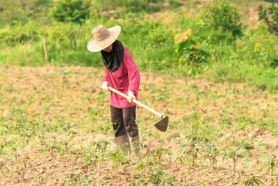 Traditional farming like the old days thai women chopping the grass in the farm alone