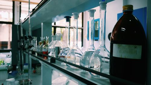 Close-up of bottles on shelf in laboratory