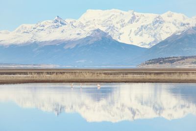 Scenic view of lake and snowcapped mountains against sky