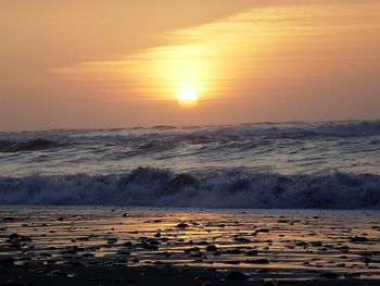 Scenic view of beach against sky during sunset