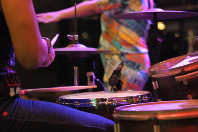 Cropped hand of man playing drum