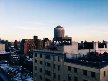 Cityscape against sky during sunset