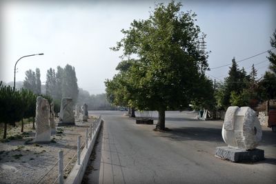 Statue in cemetery against sky